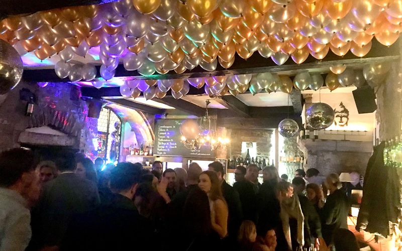 Packed dance floor under a ceiling of balloons on a Friday night at Dipso
