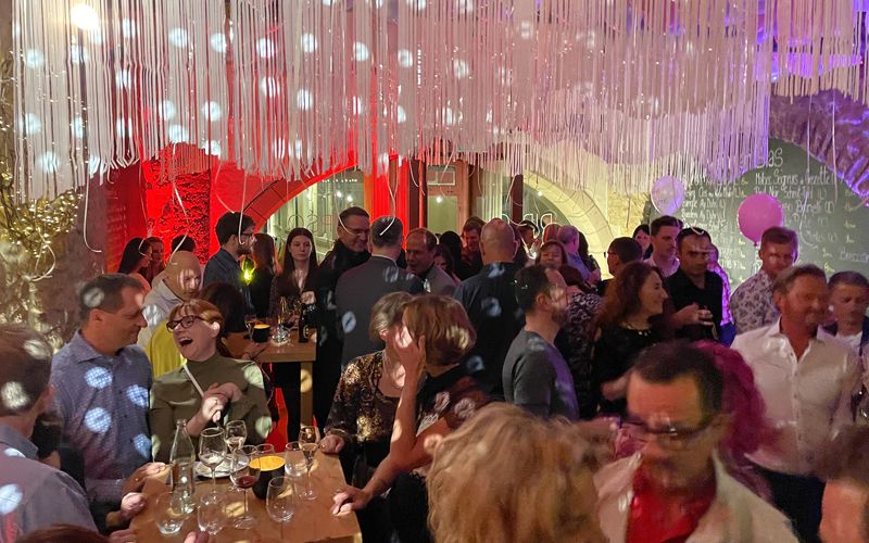 Guests celebrating under a decorated ceiling during a privatized evening